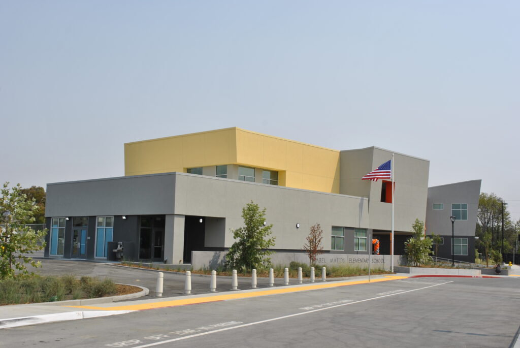 Wide exterior view of the Mabel Mattos Elementary School campus, showcasing the modern two-story administration and classroom buildings.