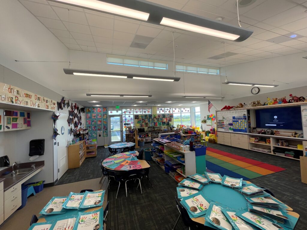 Engaging and colorful learning space inside a TK classroom at Old Adobe School, with shelves and seating for students.